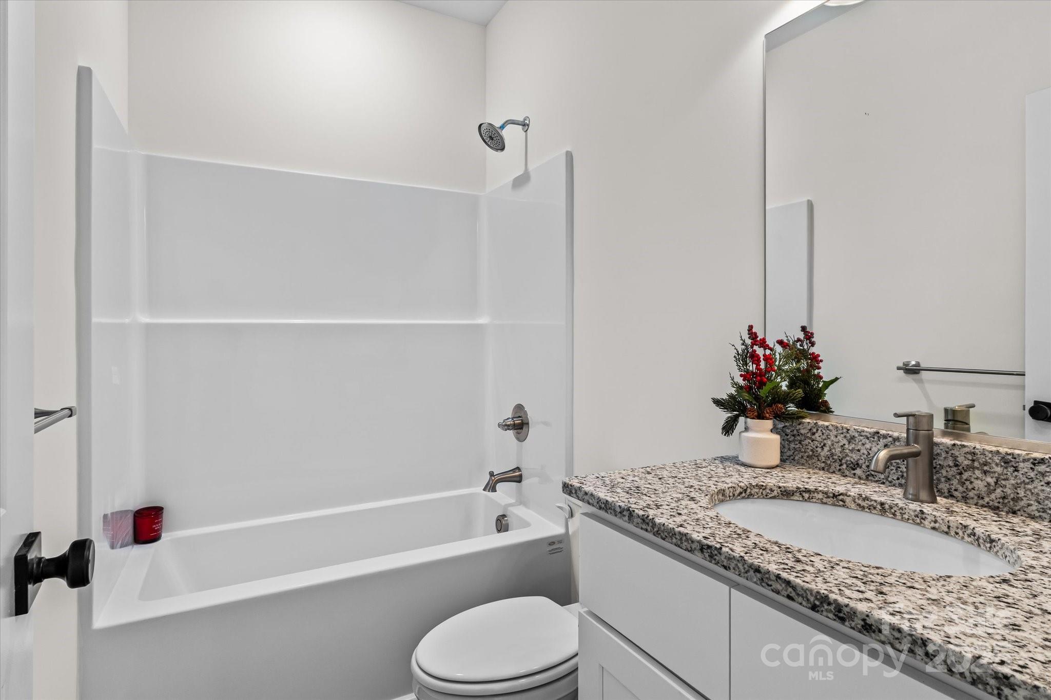 402 North Ward Avenue High Point, NC 27262 - Photo 17 of 24 a bathroom with a granite countertop sink toilet and shower