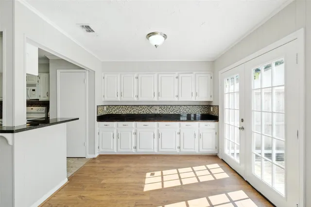 a kitchen with granite countertop a refrigerator a sink and dishwasher