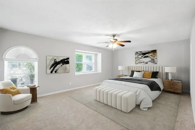 an empty room with windows and chandelier fan
