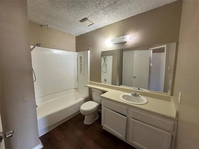 a bathroom with a double vanity sink toilet mirror and bathtub