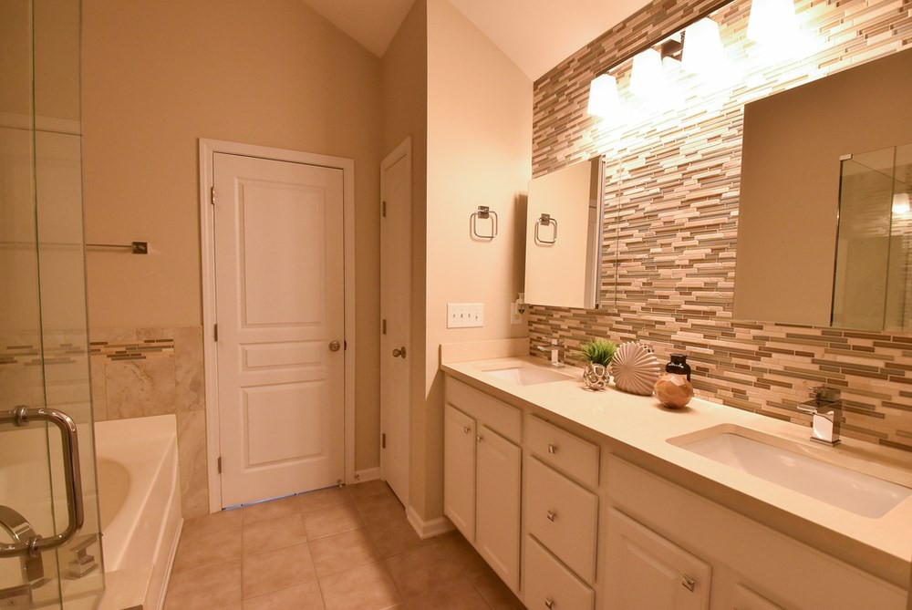 5809 Hourglass Court Raleigh, NC 27612 - Photo 16 of 30 Updated private tiled Master Bath w/lg tiled shower, soaking tub, double sinks and tons of storage in long vanity, linen closet and double medicine cabinets/mirrors. Master Bath/Spa