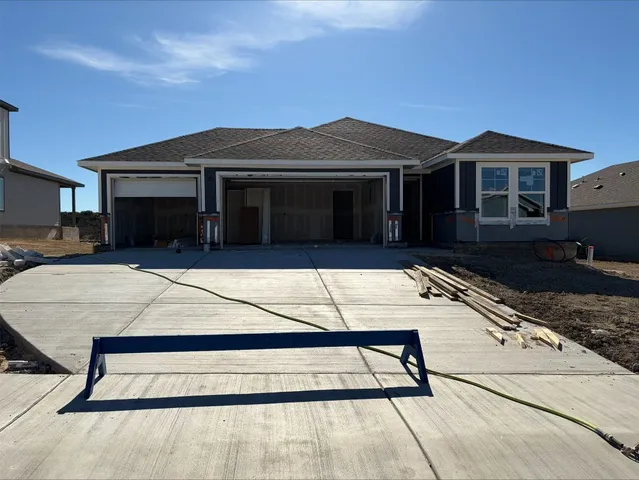 a view of a house with a large window and a yard