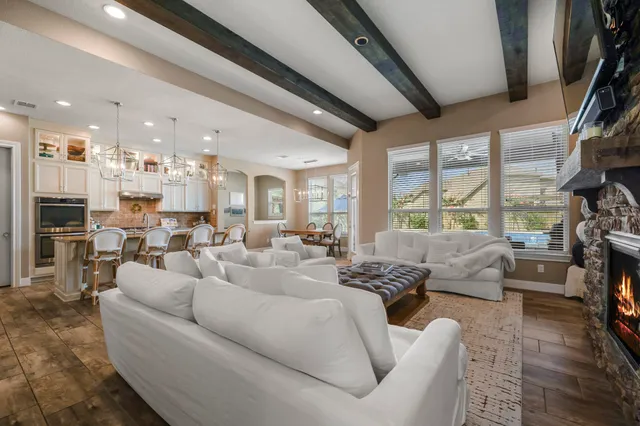 a living room with furniture fireplace and a large window