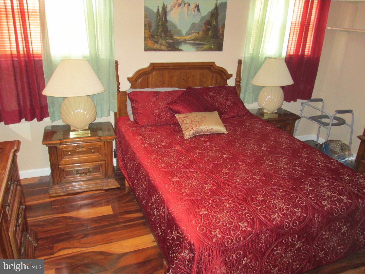 9947 Verree Road Philadelphia, PA 19115 - Photo 22 of 24 a bed sitting in a bedroom next to a lamp