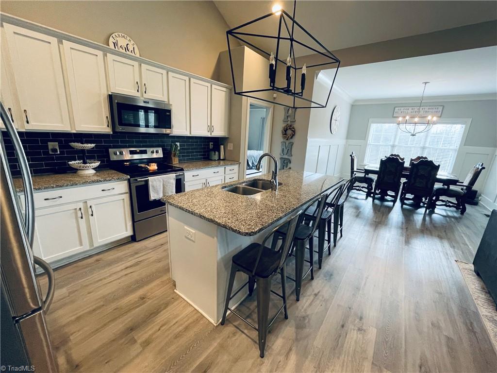 8805 Colgate Road Stokesdale, NC 27357 - Photo 3 of 34 View from kitchen with solid surface counter tops looking into the dining area. Great for entertaining.