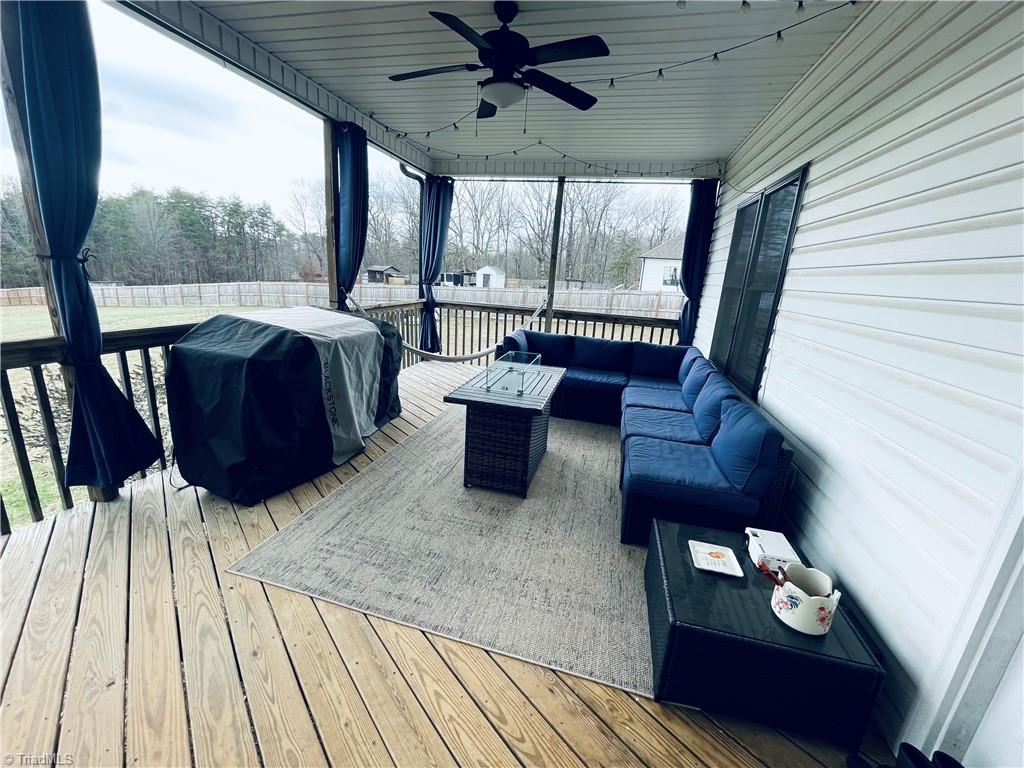 8805 Colgate Road Stokesdale, NC 27357 - Photo 24 of 34 Large covered back porch overlooking a large fenced in back yard with a chicken house and raised garden boxes