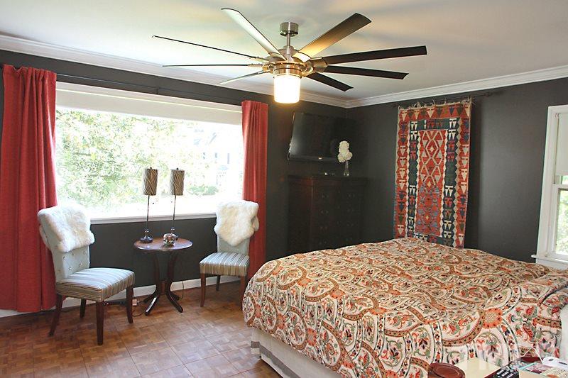 809 Currituck Drive Raleigh, NC 27609 - Photo 5 of 14 a bedroom with a bed and a chandelier