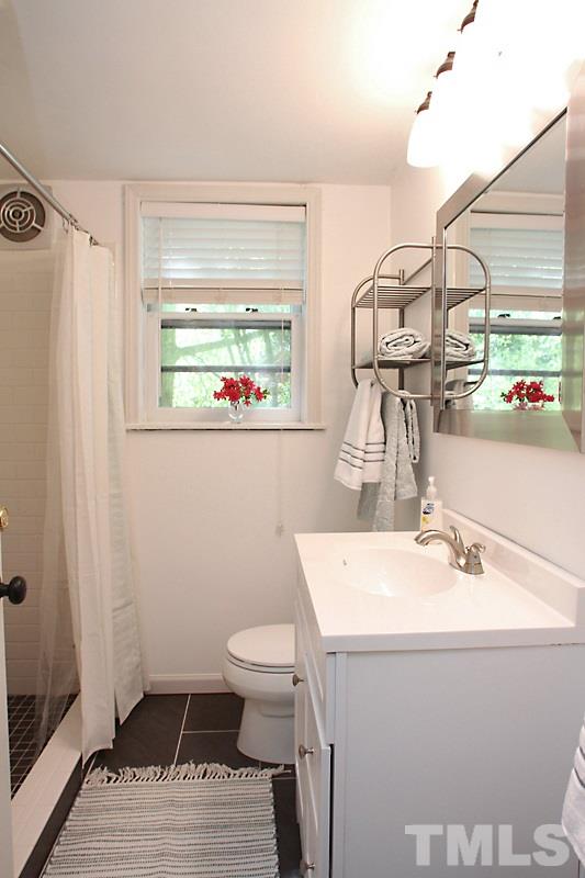 809 Currituck Drive Raleigh, NC 27609 - Photo 6 of 14 a bathroom with a sink and a mirror