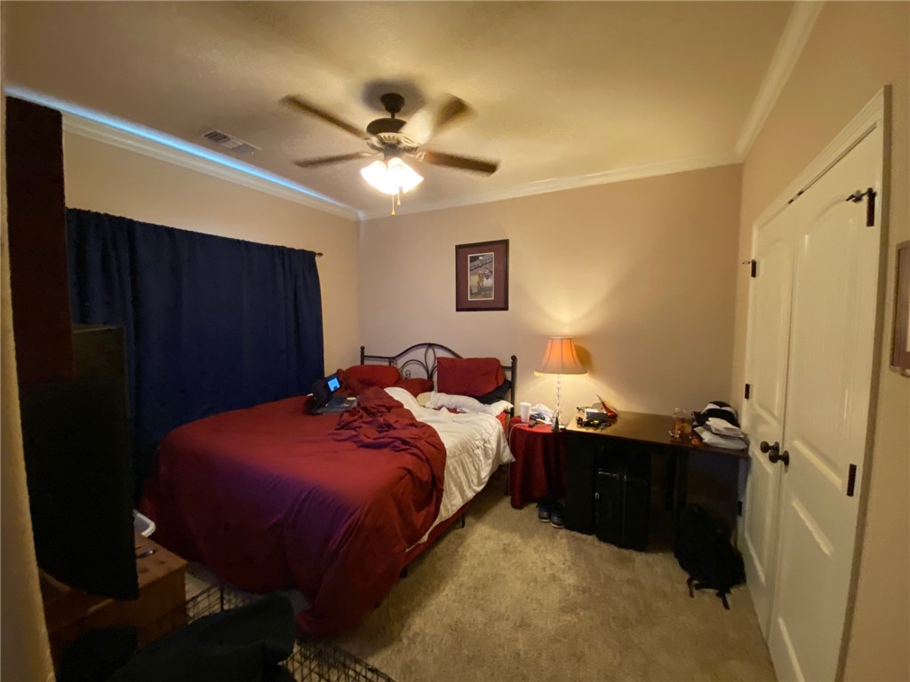 4261 Rocky Rhodes Drive College Station, TX 77845 - Photo 11 of 16 a bed room with a bed and a ceiling fan