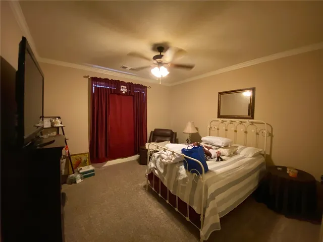 a bed room with bed and a ceiling fan