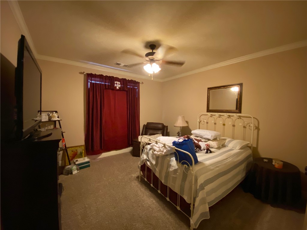 4261 Rocky Rhodes Drive College Station, TX 77845 - Photo 12 of 16 a bed room with bed and a ceiling fan