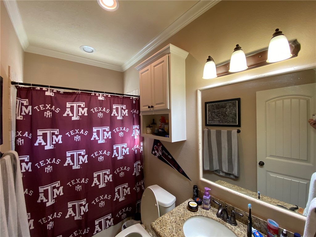4261 Rocky Rhodes Drive College Station, TX 77845 - Photo 13 of 16 a bathroom with a sink and a mirror