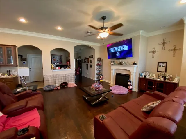 a living room with furniture fireplace and a large window