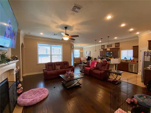 a living room with furniture and a flat screen tv