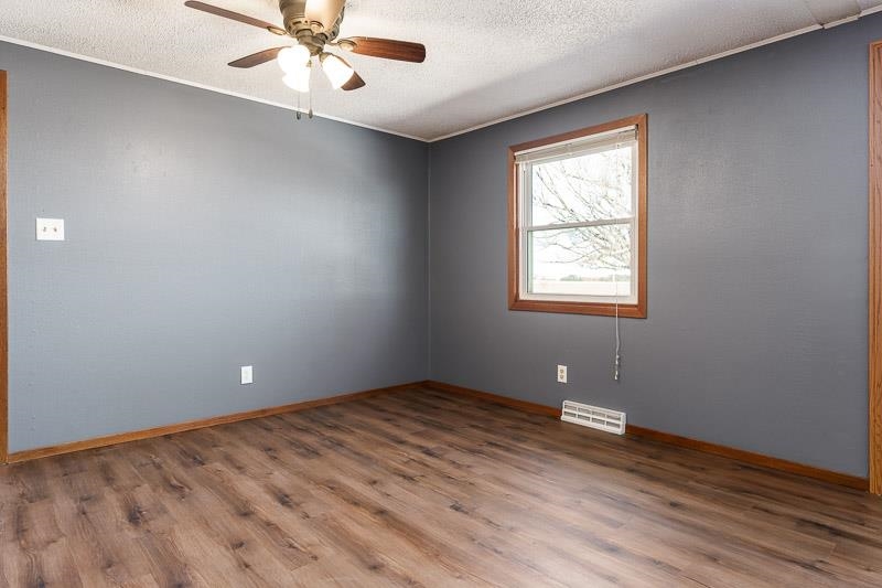 4422 North Union Road Forreston, IL 61030 - Photo 36 of 60 an empty room with wooden floor and windows