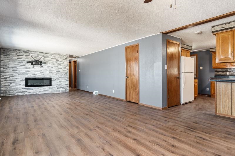 4422 North Union Road Forreston, IL 61030 - Photo 38 of 60 a view of empty room with wooden floor and fireplace