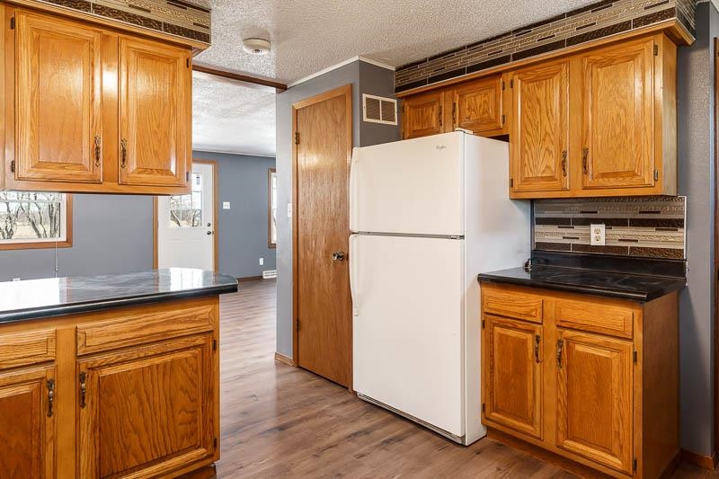 4422 North Union Road Forreston, IL 61030 - Photo 43 of 60 a white refrigerator freezer sitting in a kitchen