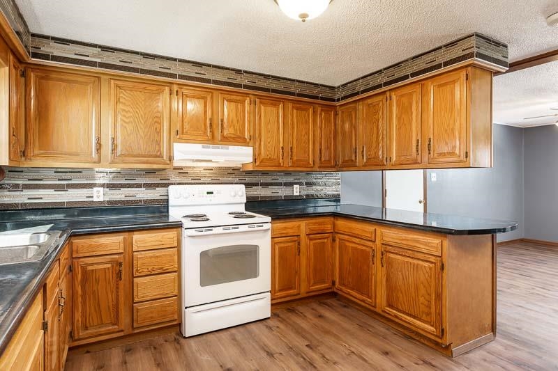 4422 North Union Road Forreston, IL 61030 - Photo 44 of 60 a kitchen with a stove a sink and a microwave