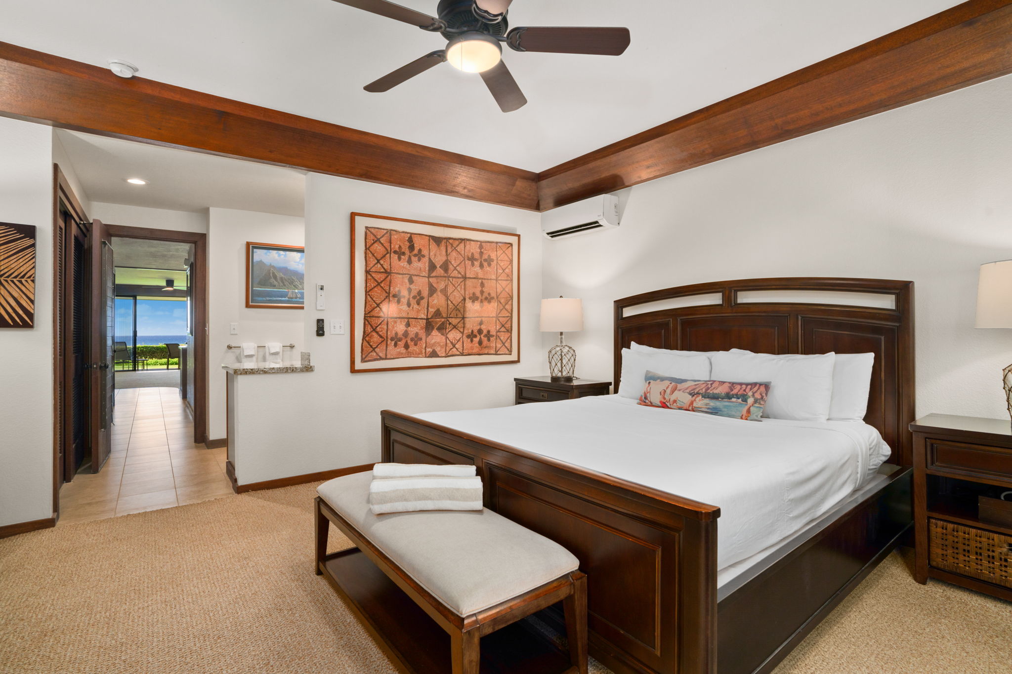 2221 Kapili Road, Unit 25 Koloa, HI 96756 - Photo 4 of 6 a bedroom with a bed and a chandelier