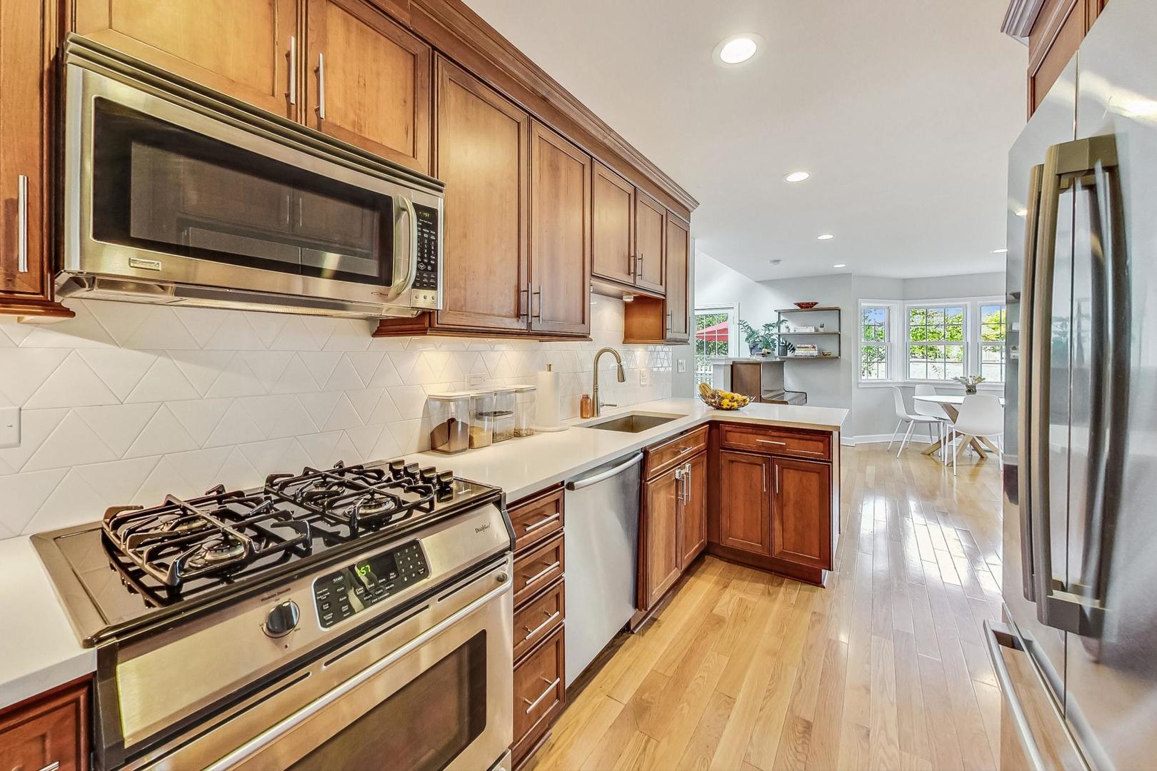 48 Williamsburg Road Evanston, IL 60203 - Photo 11 of 42 a kitchen with stainless steel appliances a stove a sink and a microwave