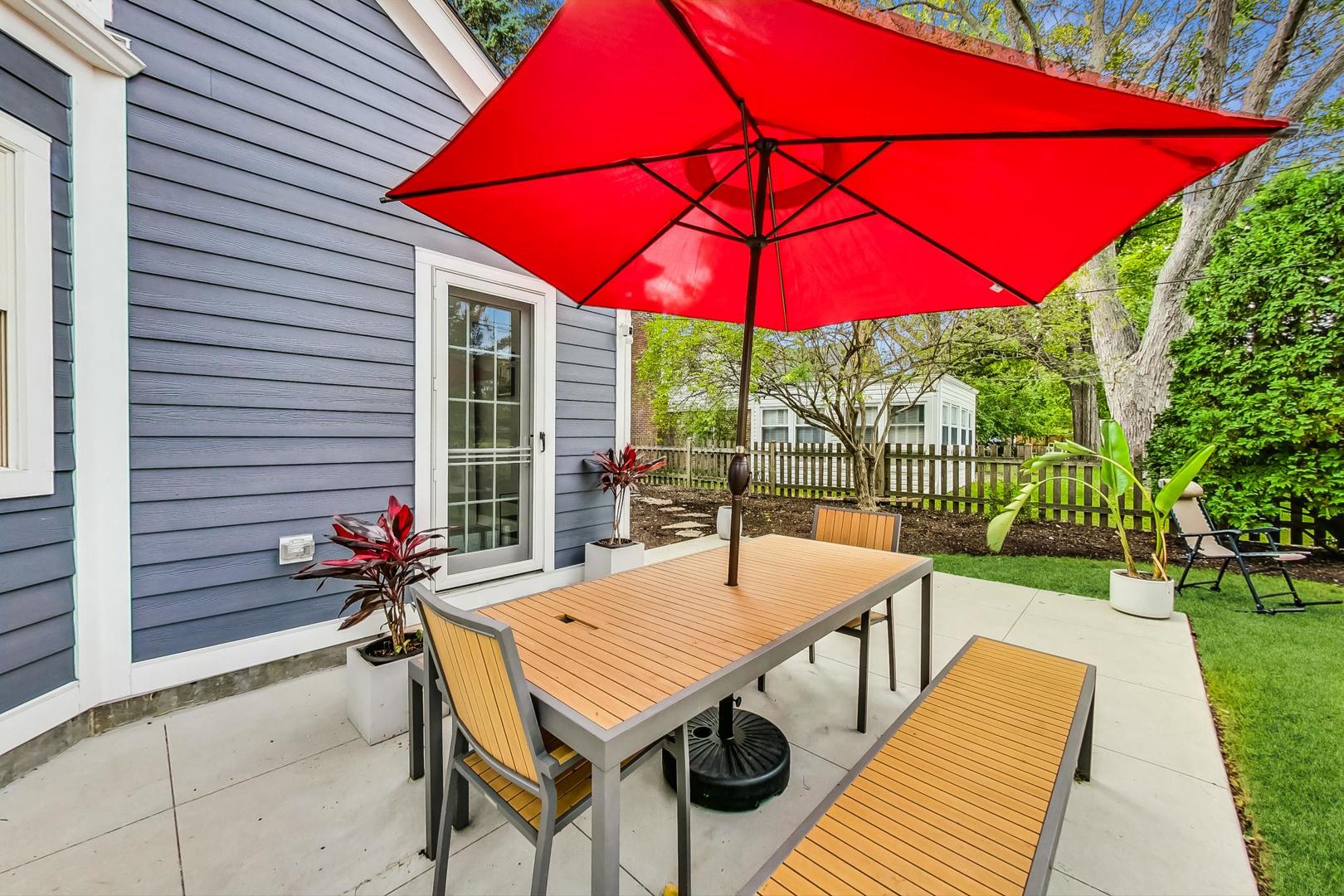 48 Williamsburg Road Evanston, IL 60203 - Photo 34 of 42 a view of a patio with a table and chairs under an umbrella