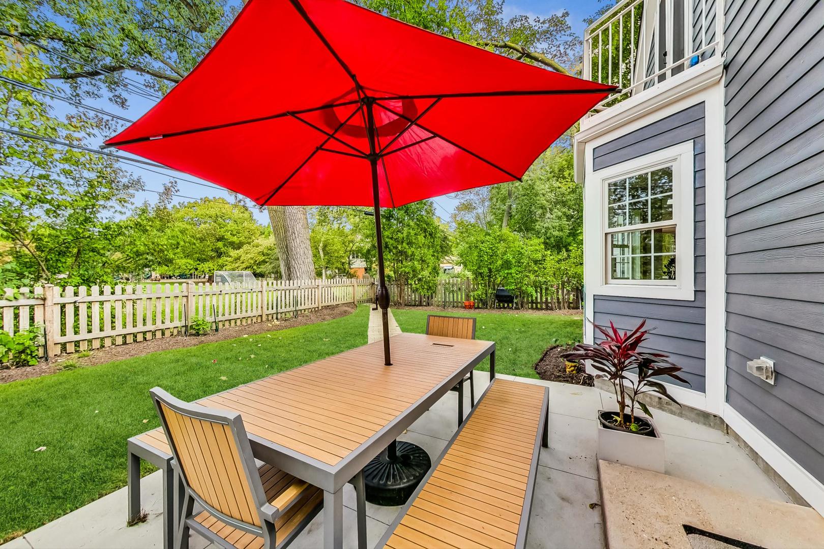 48 Williamsburg Road Evanston, IL 60203 - Photo 35 of 42 a view of a patio with a table and chairs under an umbrella