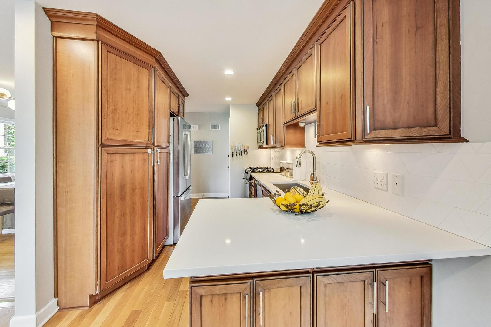 48 Williamsburg Road Evanston, IL 60203 - Photo 9 of 42 a kitchen with a refrigerator and a sink