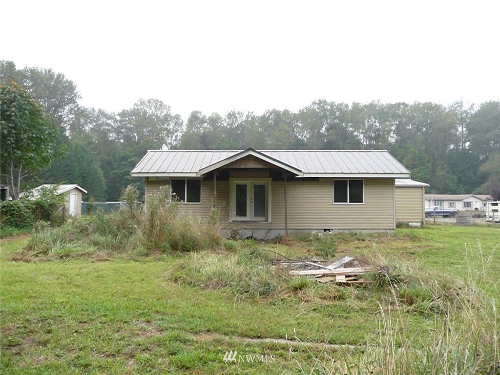 181 Head Gate Road Sequim, WA 98382 - Photo 3 of 18 a view of a house with a yard