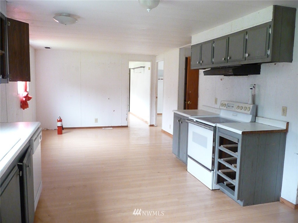 181 Head Gate Road Sequim, WA 98382 - Photo 6 of 18 a kitchen with kitchen island granite countertop a stove and a sink
