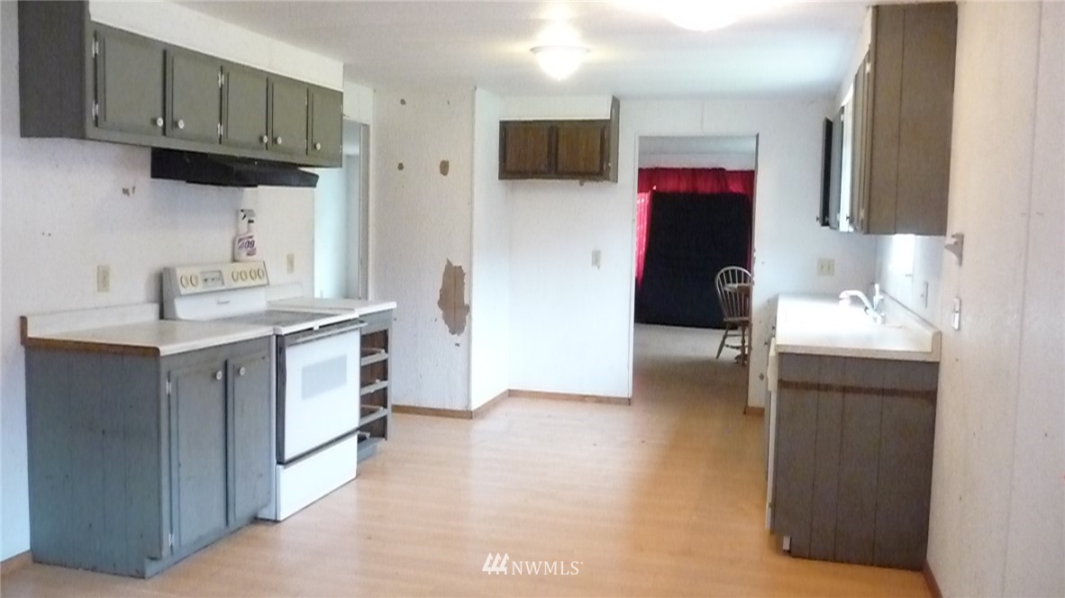 181 Head Gate Road Sequim, WA 98382 - Photo 8 of 18 a kitchen with a sink cabinets and a refrigerator