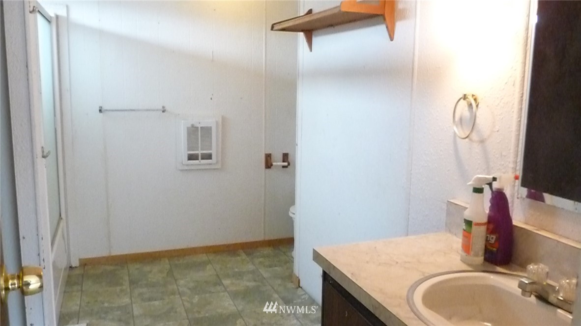 181 Head Gate Road Sequim, WA 98382 - Photo 10 of 18 a bathroom with a granite countertop sink and a mirror