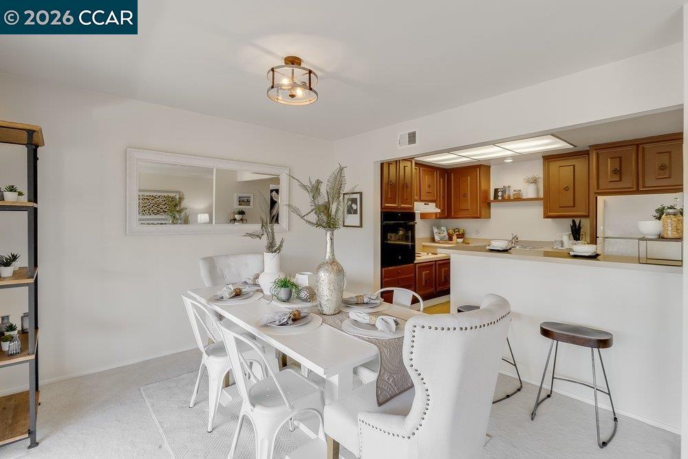 2801 Golden Rain Road, Unit 3 Walnut Creek, CA 94595 - Photo 12 of 29 a kitchen with a dining table and chairs
