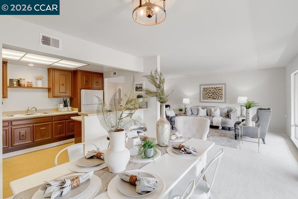 2801 Golden Rain Road, Unit 3 Walnut Creek, CA 94595 - Photo 14 of 29 a living room with furniture and a dining table with wooden floor