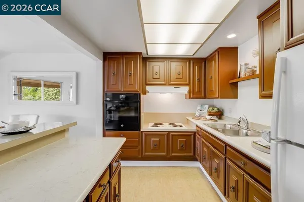 a kitchen that has a sink and a stove