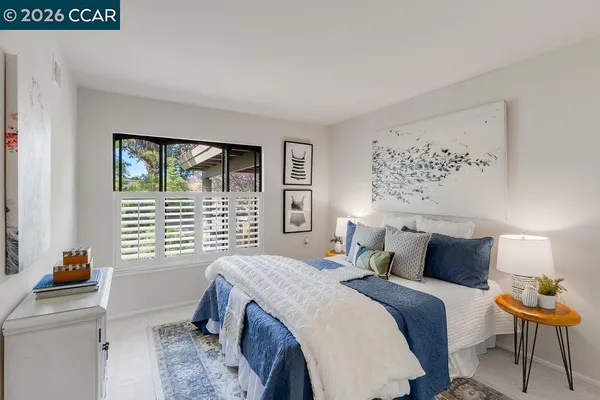 a bedroom with a bed and a window