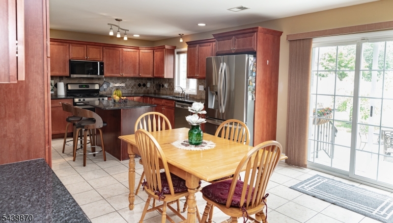 419 Putnam Road Union, NJ 07083 - Photo 12 of 37 a view of a dining room with furniture a chandelier and kitchen view