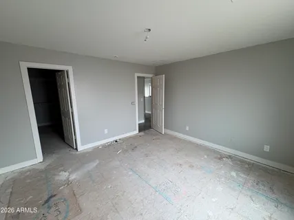 a view of a big room with wooden floor and windows