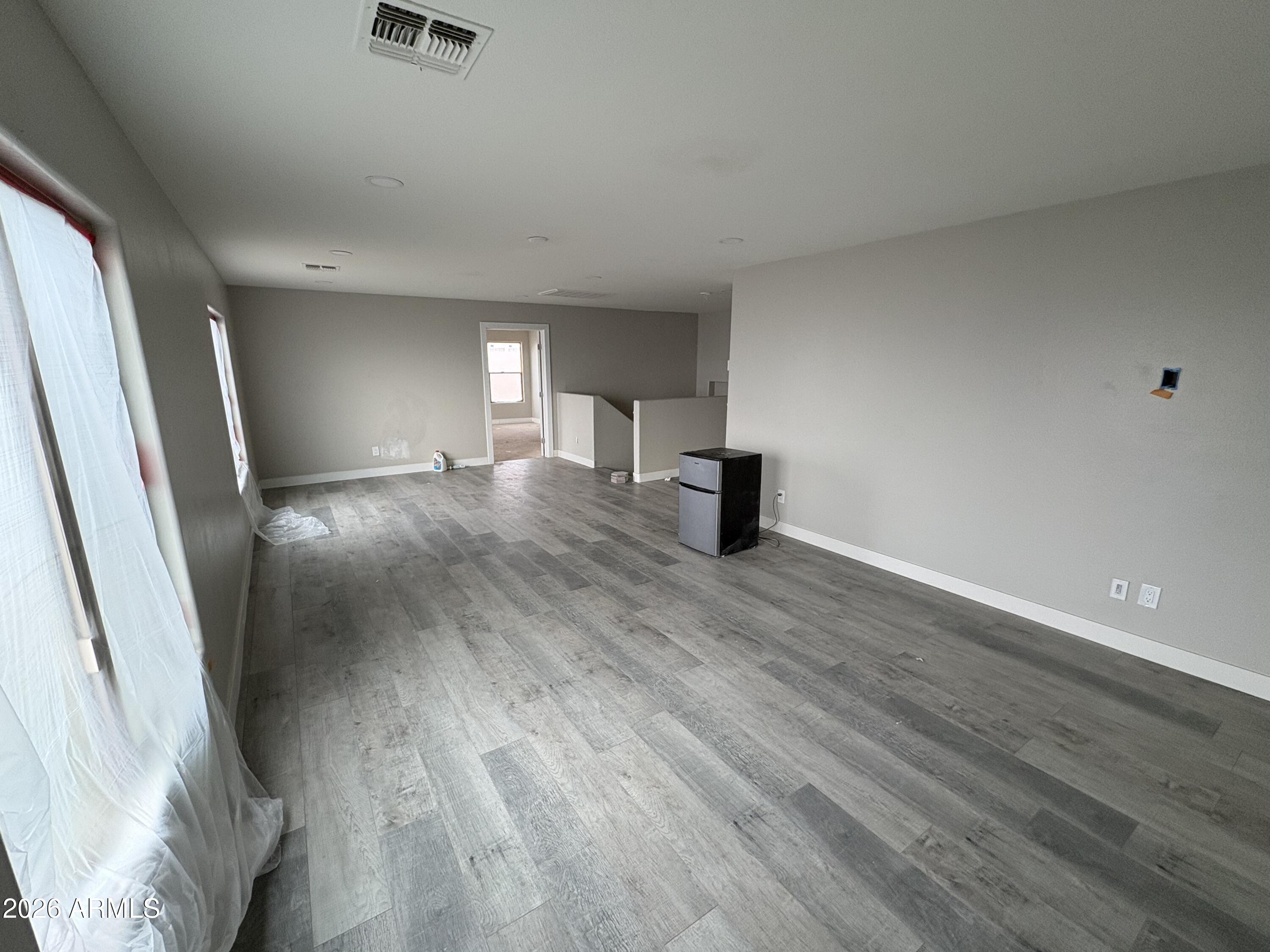 951 West Elizabeth Way Coolidge, AZ 85128 - Photo 17 of 20 a view of a big room with wooden floor and windows
