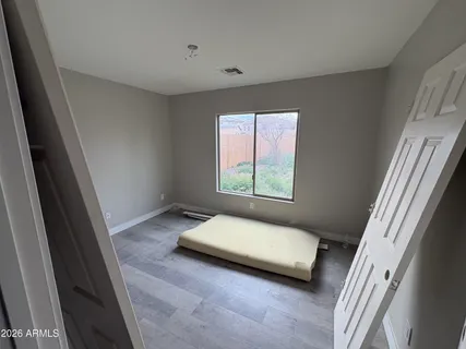 a bedroom with a bed and a window