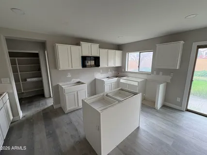 a kitchen with a stove a sink and a microwave