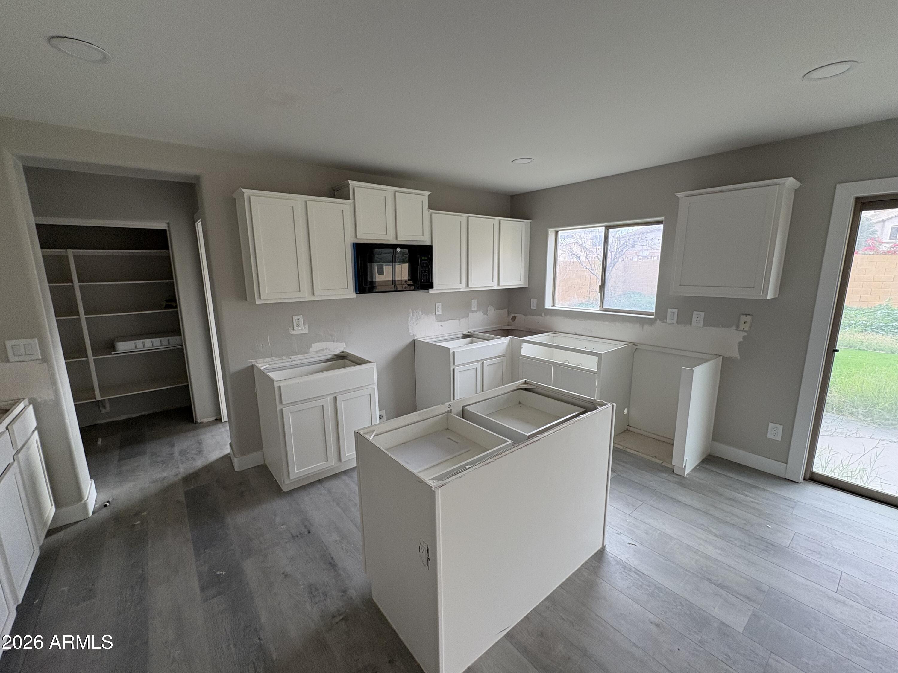 951 West Elizabeth Way Coolidge, AZ 85128 - Photo 8 of 20 a kitchen with a stove a sink and a microwave