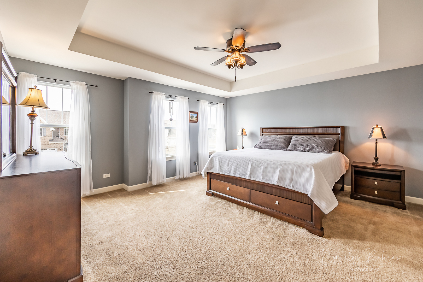 4354 Rudyard Kipling Road Elgin, IL 60124 - Photo 18 of 23 a spacious bedroom with a bed and a chandelier