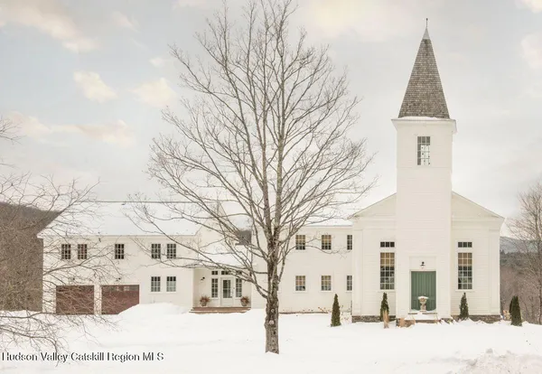 a view of a white house with a yard