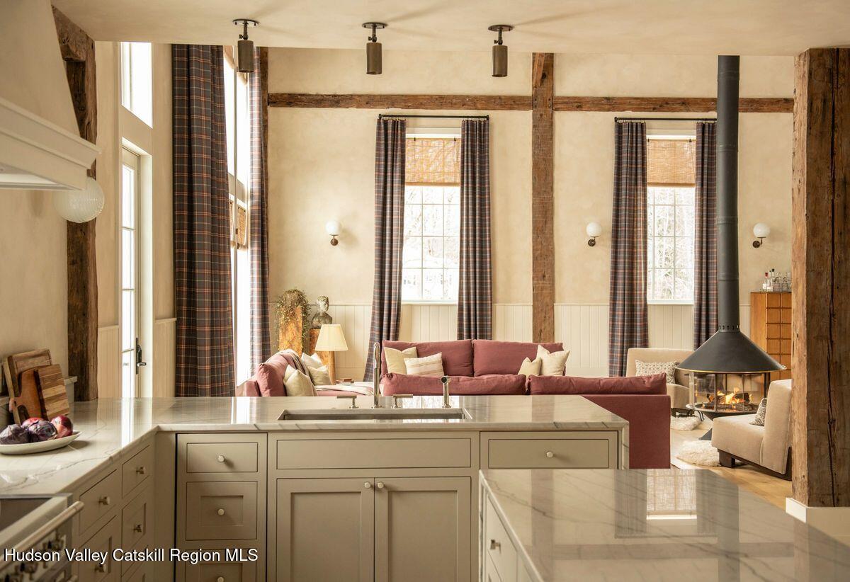 1174 Potter Mountain Road Gilboa, NY 12076 - Photo 11 of 33 a bath room with a sink and a large mirror next to a window