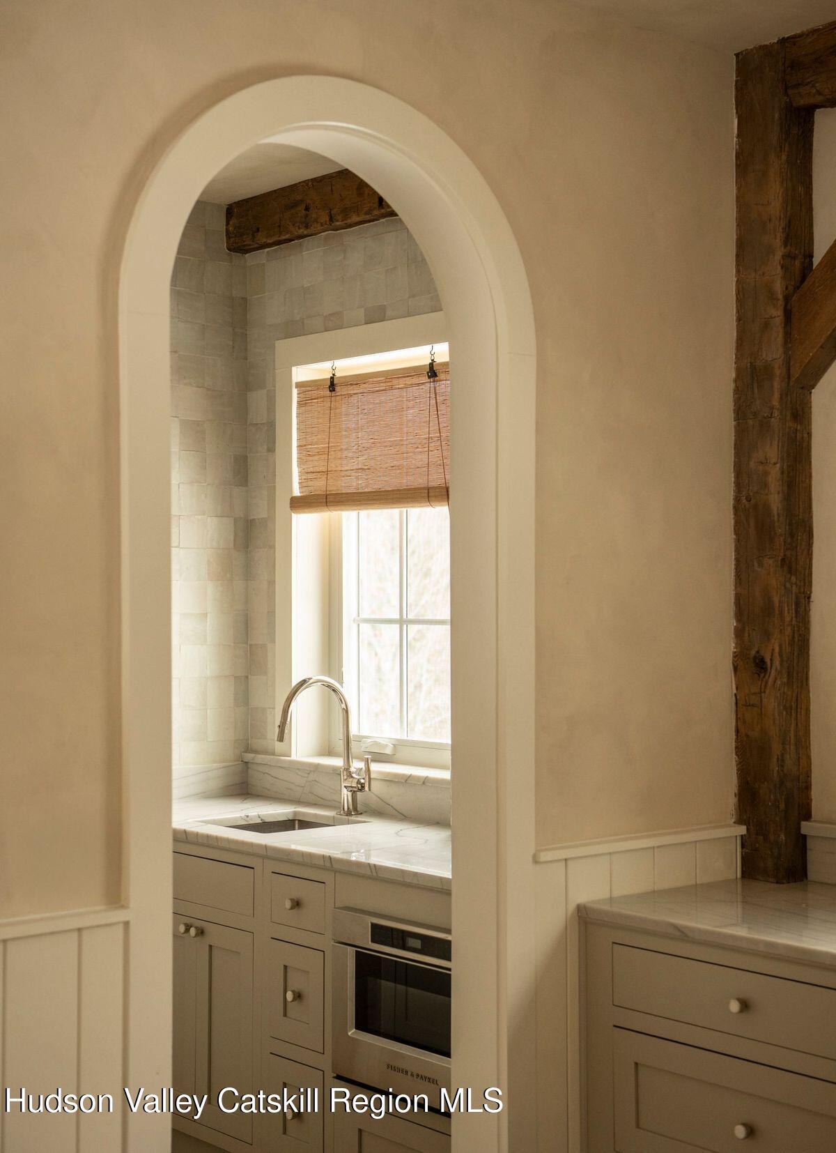 1174 Potter Mountain Road Gilboa, NY 12076 - Photo 14 of 33 a bathroom with a sink a mirror and a window