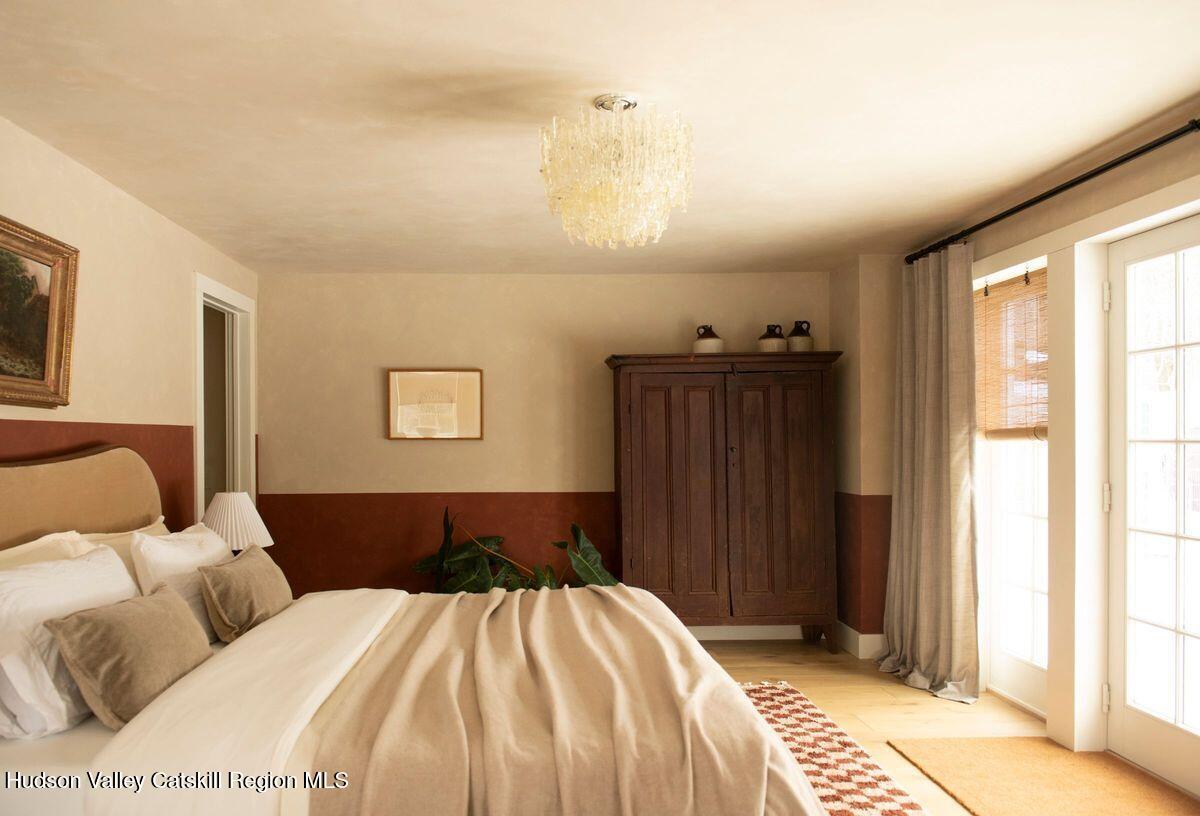 1174 Potter Mountain Road Gilboa, NY 12076 - Photo 19 of 33 a bedroom with a bed and wooden floor