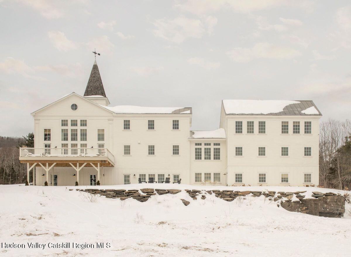 1174 Potter Mountain Road Gilboa, NY 12076 - Photo 32 of 33 a view of a large white building with a snow in the background