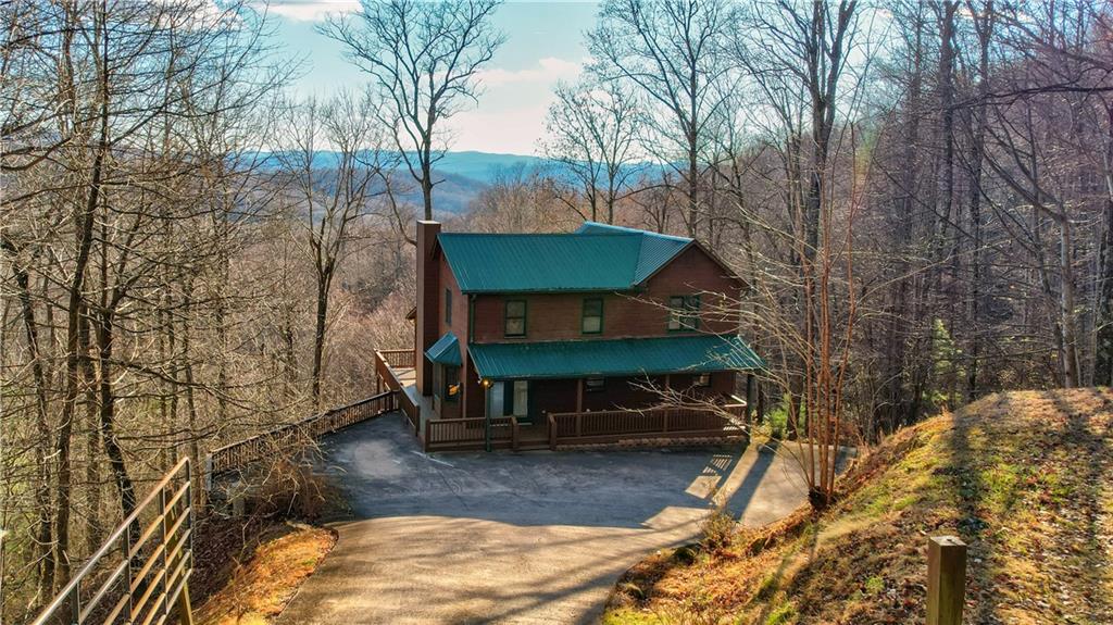 65 Prospectors Ridge Ellijay, GA 30536 - Photo 1 of 1 a view of a house with a yard fire pit and outdoor seating