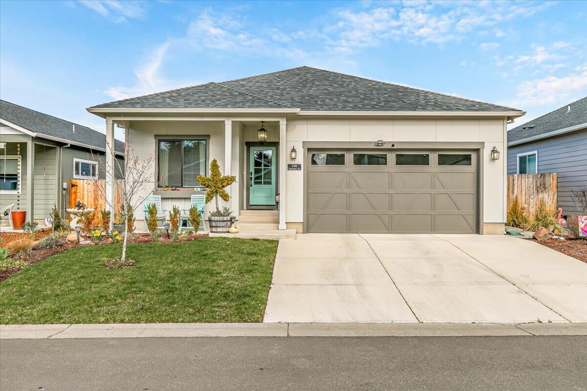 248 Christopher Way Talent, OR 97540 - Photo 1 of 33 a front view of a house with a garden and plants
