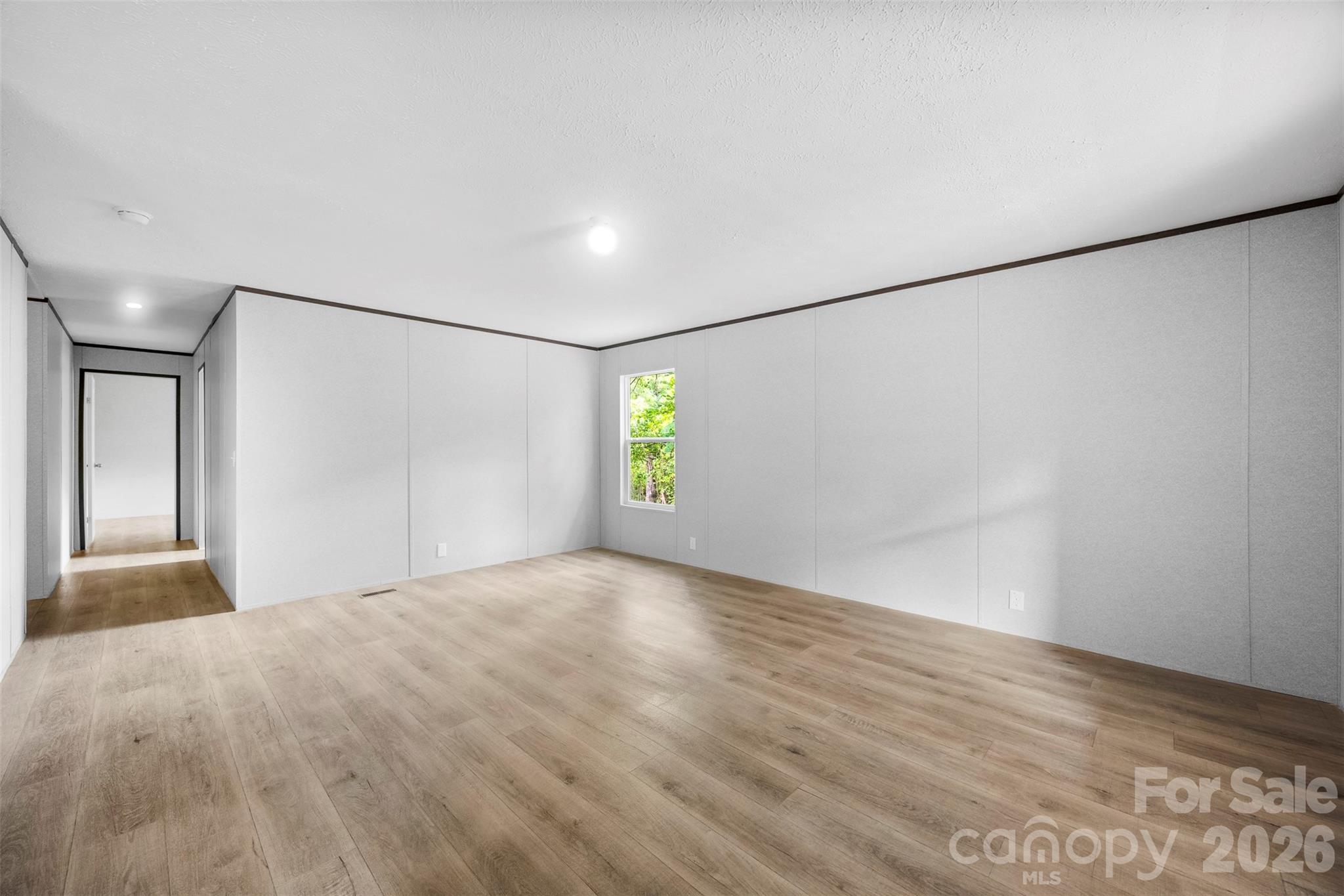 321 Bell Road Kings Mountain, NC 28086 - Photo 10 of 32 a view of an empty room with window and wooden floor